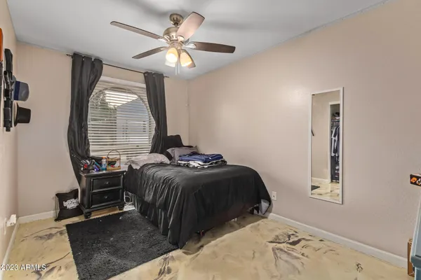 a bedroom with a bed and a chandelier