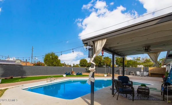a view of a swimming pool with outdoor seating and yard
