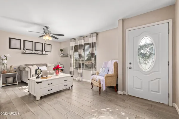 a living room with furniture and a chandelier