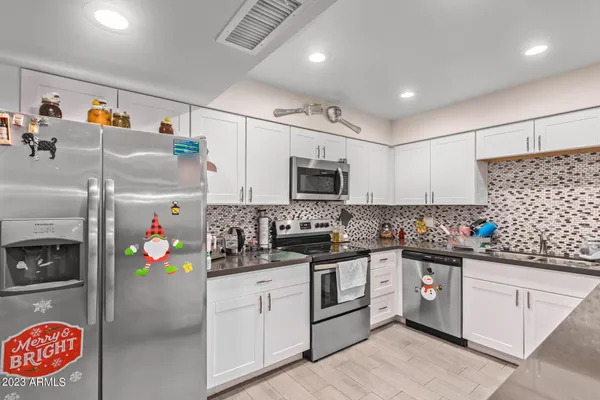 a kitchen with stainless steel appliances granite countertop a sink and cabinets
