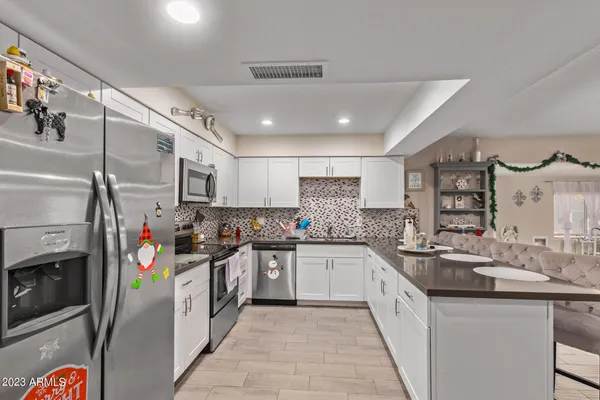 a kitchen with stainless steel appliances granite countertop a sink and cabinets