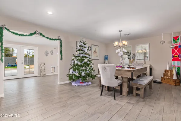 a dining room with furniture and chandelier