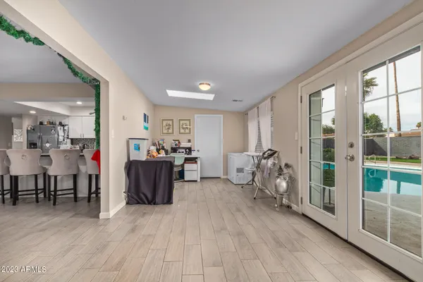 a living room with furniture a large window and wooden floor