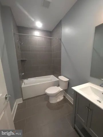 a bathroom with a toilet a sink and bathtub