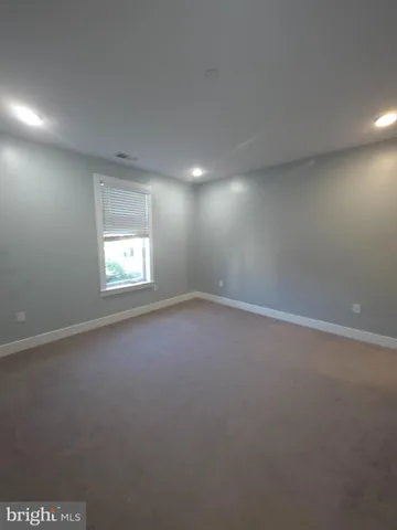 an empty room with a empty space and windows