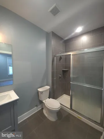 a bathroom with a toilet and a shower