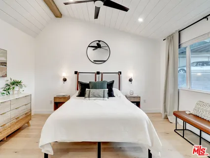 a bedroom with bed and a table