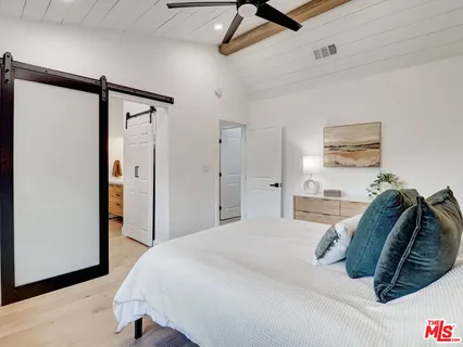 a bedroom with a bed and a walk in closet