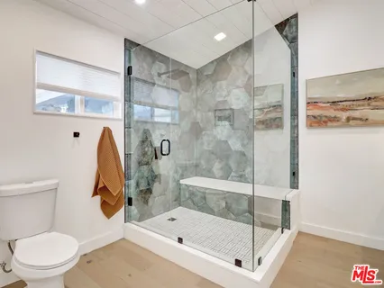 a bathroom with a shower a toilet and a shower