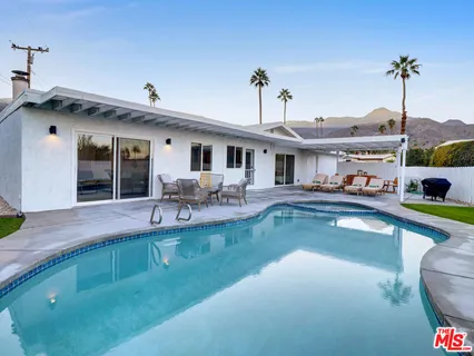 a view of a house with swimming pool yard and patio
