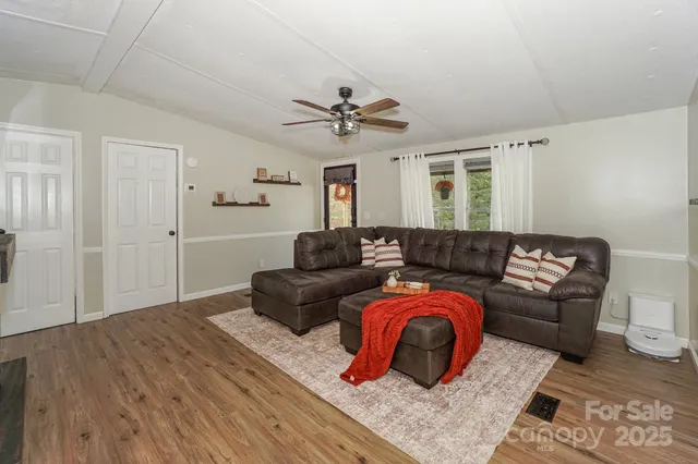 a living room with furniture a ceiling fan and a rug