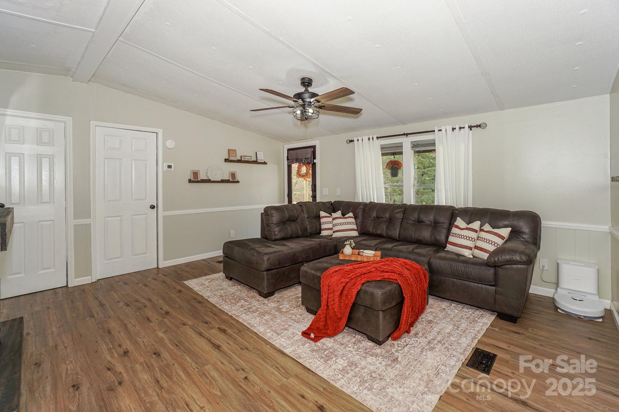 1279 Craig Drive Iron Station, NC 28080 - Photo 11 of 47 a living room with furniture ceiling fan and a rug