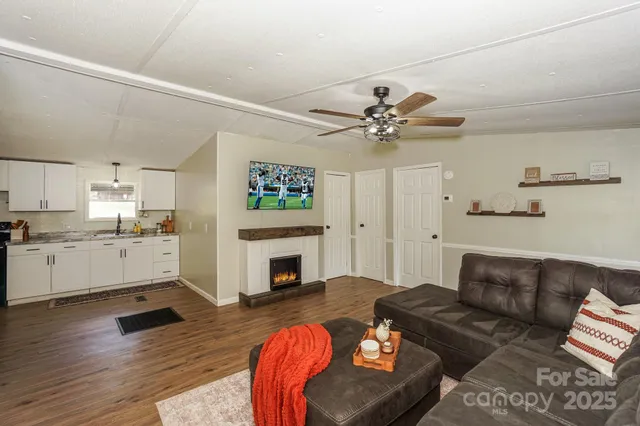 a kitchen with granite countertop white cabinets and stainless steel appliances