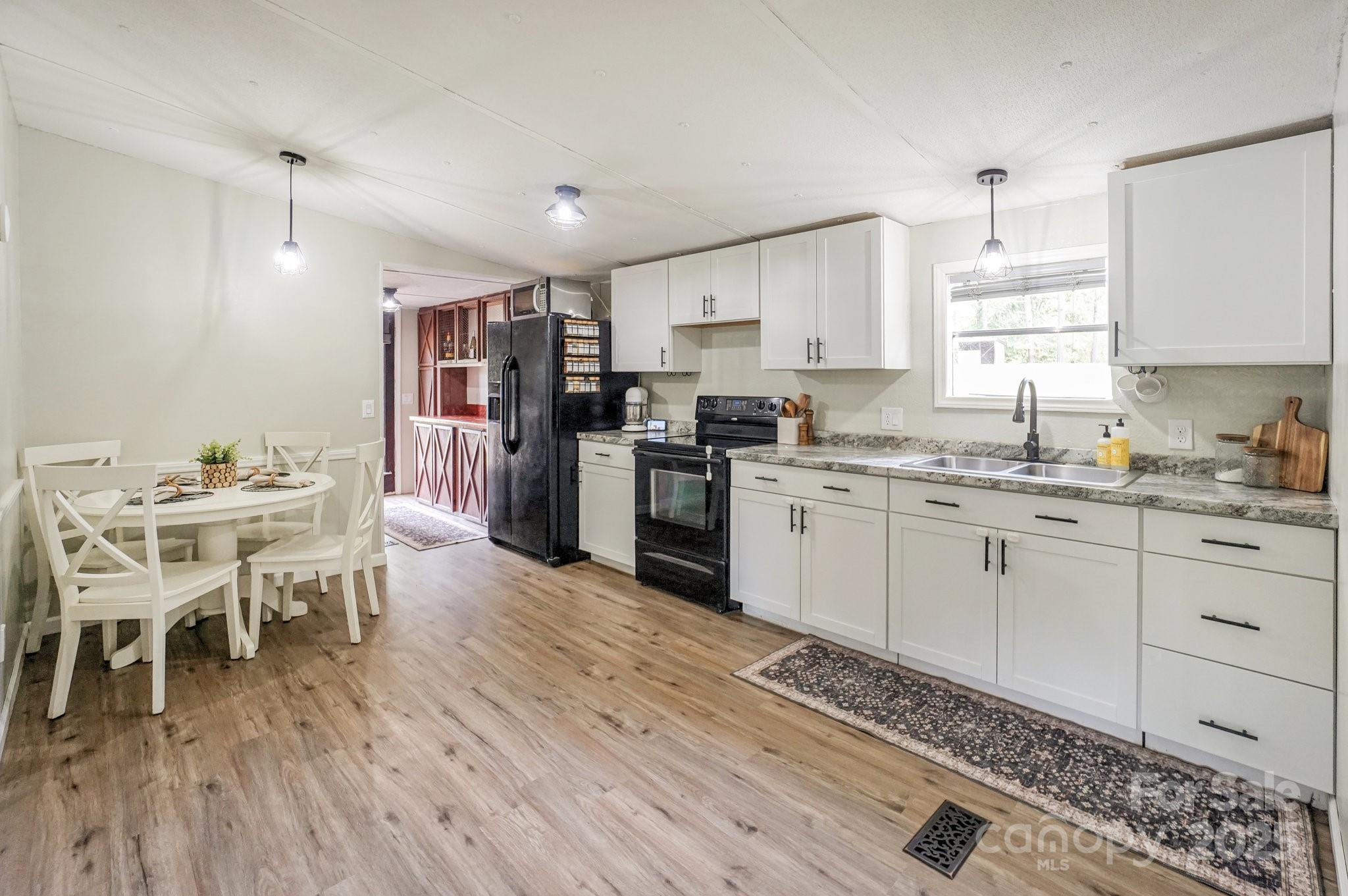 1279 Craig Drive Iron Station, NC 28080 - Photo 15 of 47 a kitchen with a sink white cabinets and stainless steel appliances