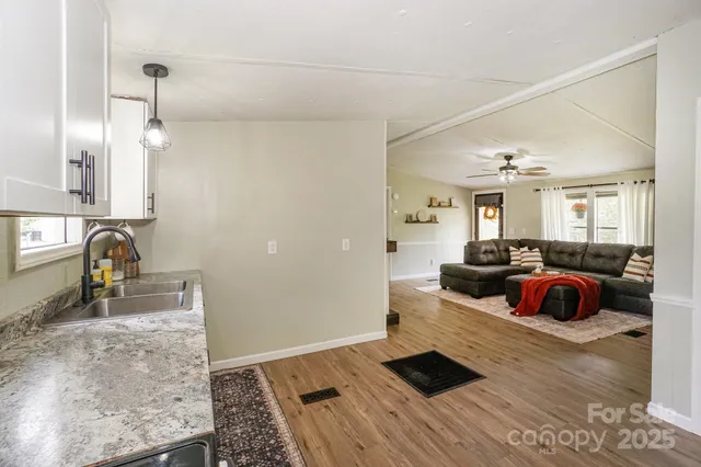 a kitchen with granite countertop a stove sink and cabinets