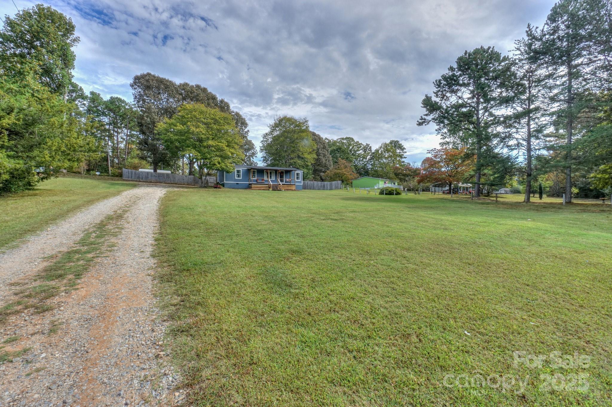 1279 Craig Drive Iron Station, NC 28080 - Photo 2 of 47 a view of a big yard with plants and large trees