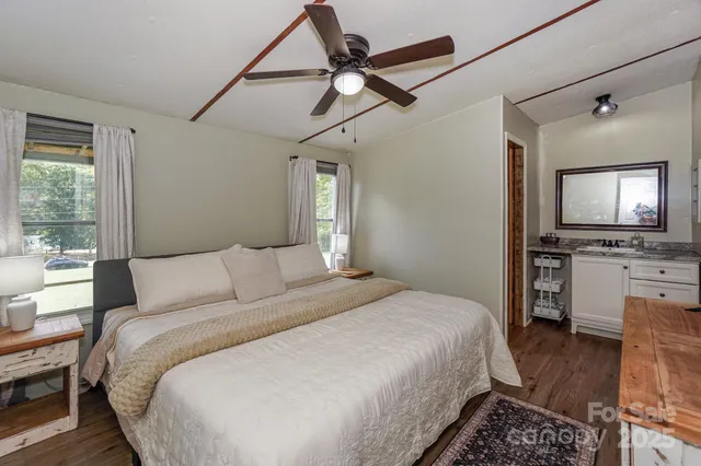 a bedroom with a large bed and a tv