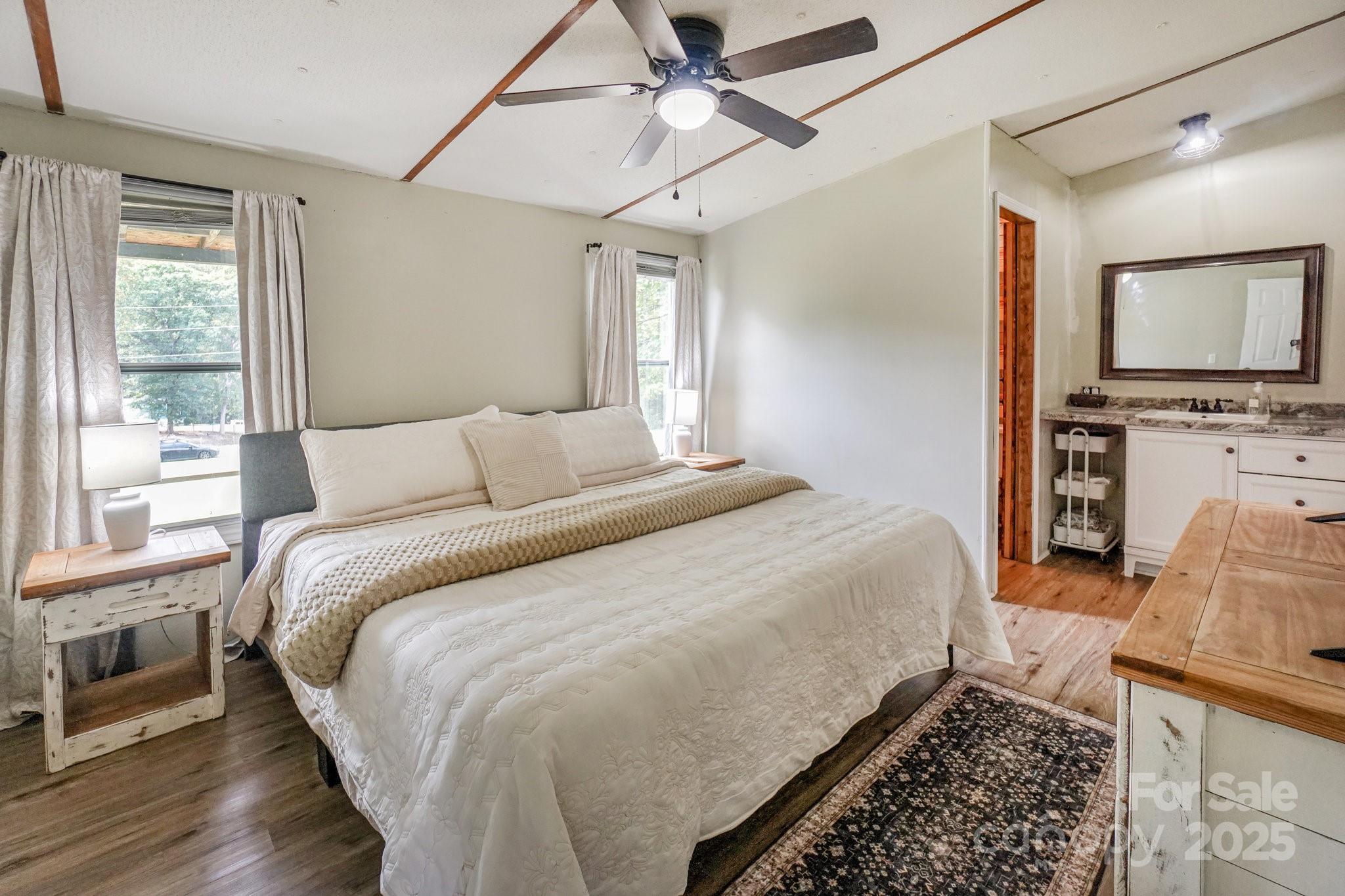 1279 Craig Drive Iron Station, NC 28080 - Photo 22 of 47 a bedroom with a large bed and a tv