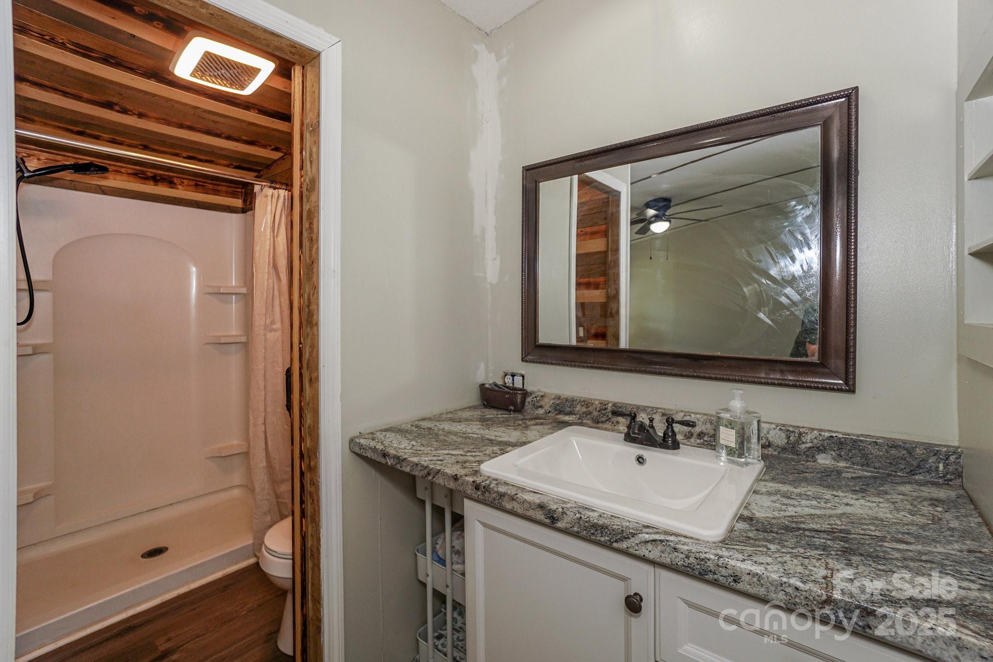1279 Craig Drive Iron Station, NC 28080 - Photo 25 of 47 a bathroom with a granite countertop sink and a mirror