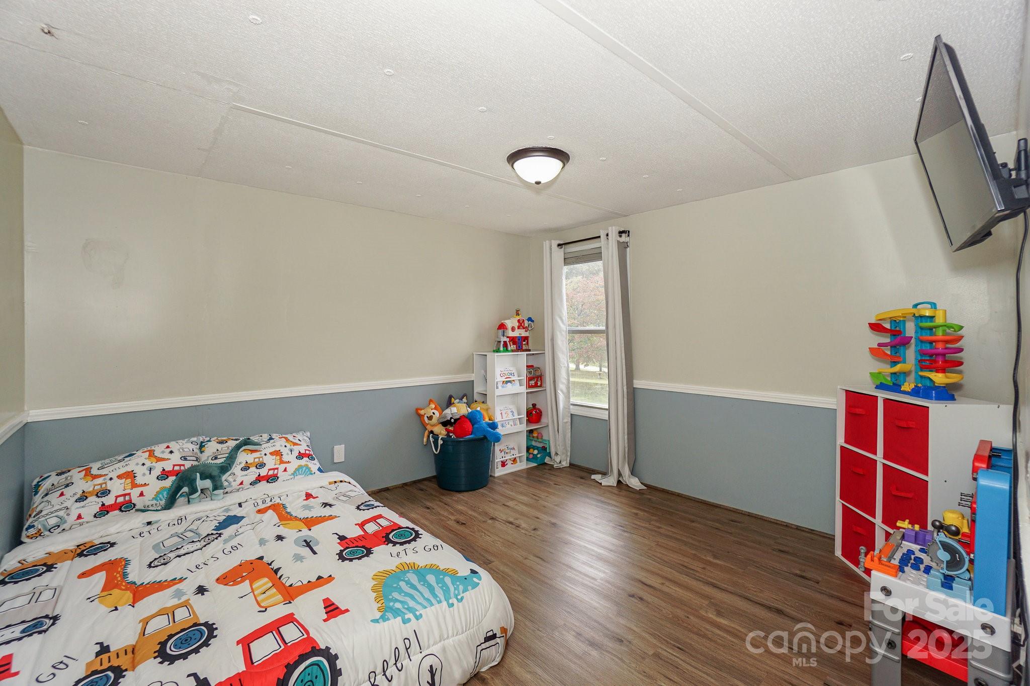 1279 Craig Drive Iron Station, NC 28080 - Photo 27 of 47 a bedroom with bed and wooden floor