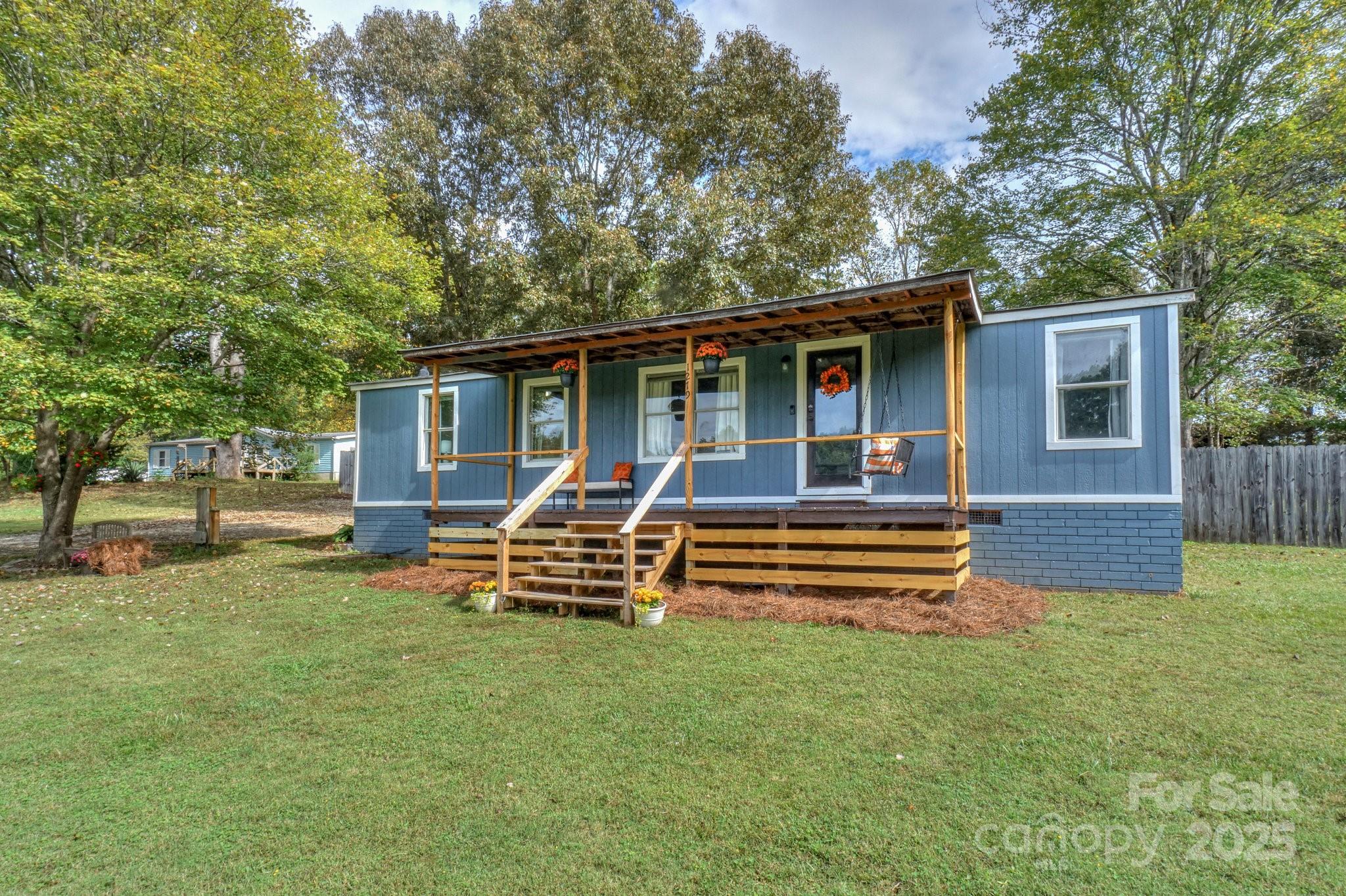 1279 Craig Drive Iron Station, NC 28080 - Photo 4 of 47 a front view of a house with garden