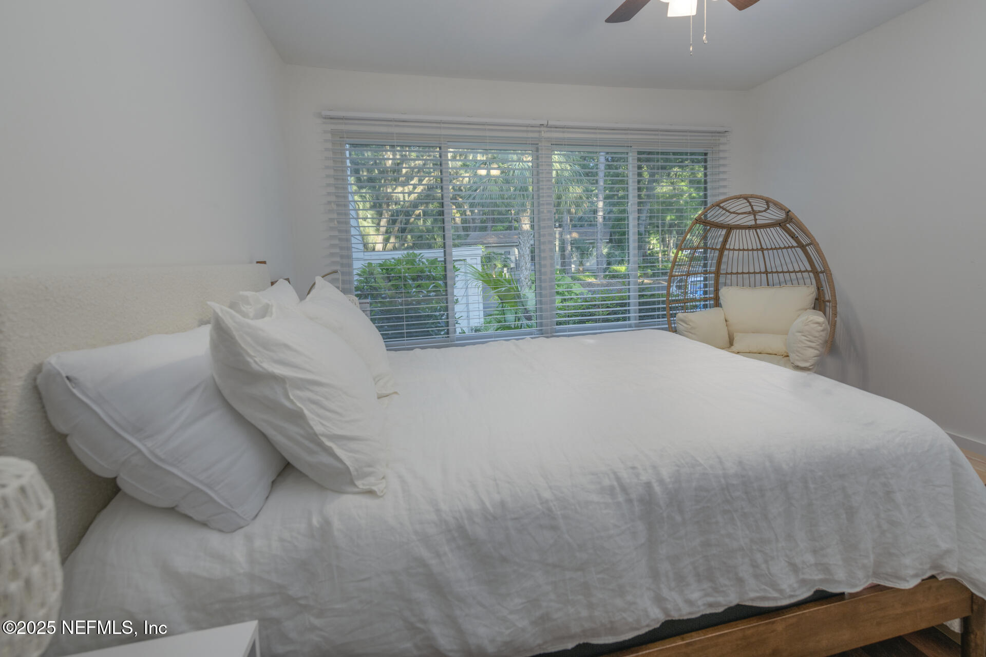 3426 Sea Marsh Road Fernandina Beach, FL 32034 - Photo 35 of 39 a bed sitting in a bedroom next to a window