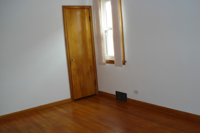 2427 Keystone Avenue North Riverside, IL 60546 - Photo 9 of 14 an empty room with wooden floor and windows