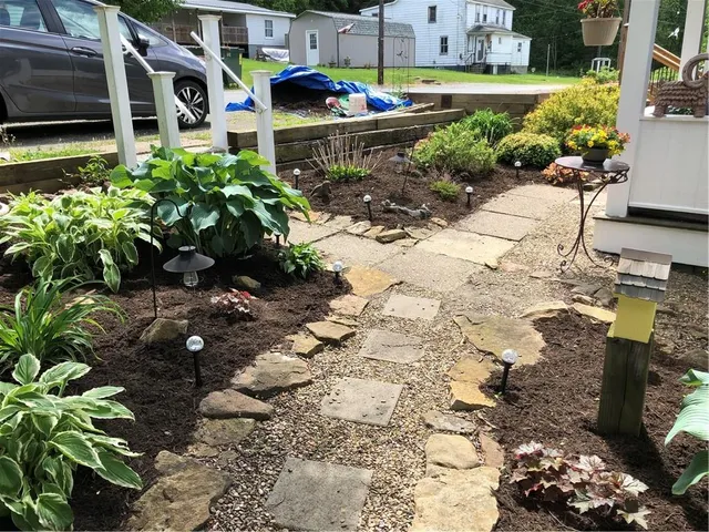 a view of a patio with table and chairs with wooden fence