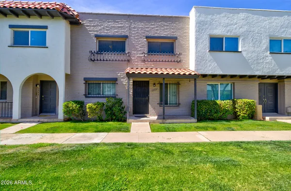 a view of a house with a yard and plants