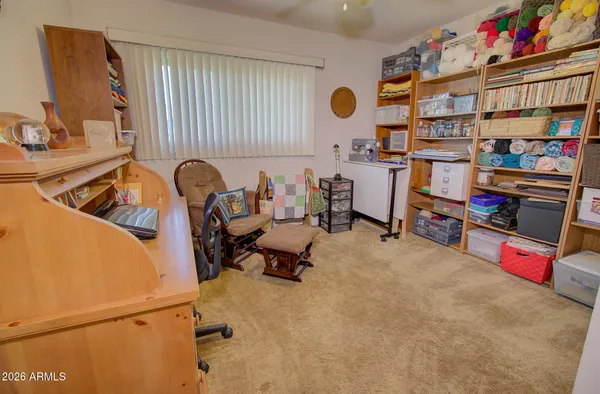 a reading room with furniture and a book shelf