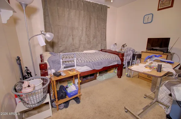 a bedroom with bed and a chandelier