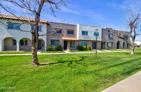 a view of a building with a yard