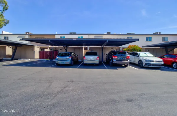 a view of a swimming pool with a table and chairs under an umbrella