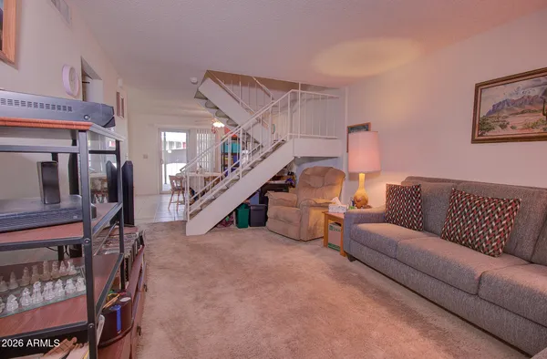 a living room with furniture and stairs
