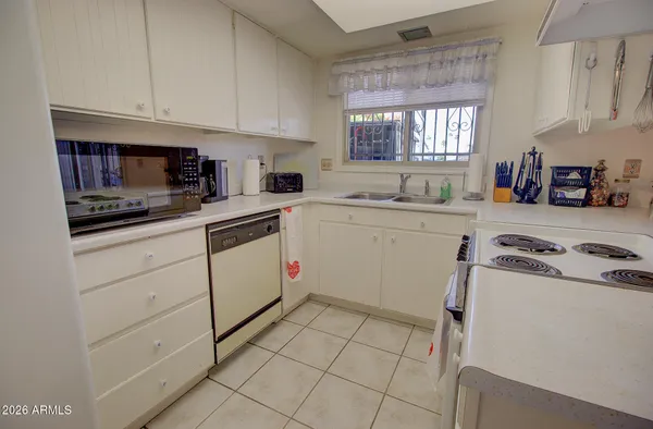 a kitchen with a sink a stove and cabinets