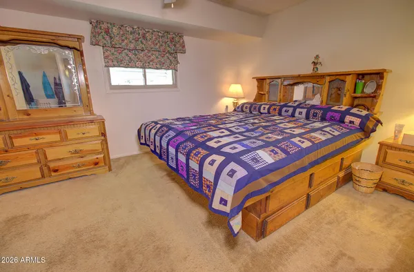 a bed sitting in a bedroom next to a window