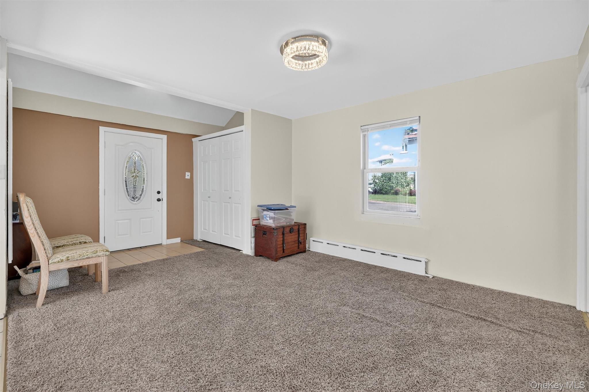 3384 Country Club Road Bronx, NY 10465 - Photo 22 of 48 Living area with a baseboard heating unit and carpet flooring