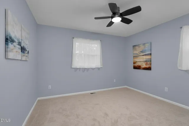 a view of room with ceiling fan and window