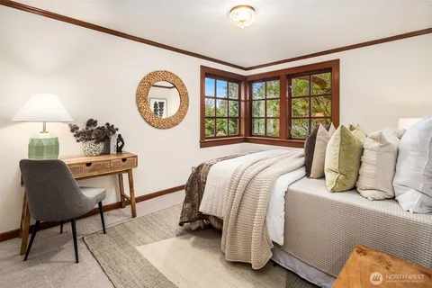 a bed room with a bed and a chair