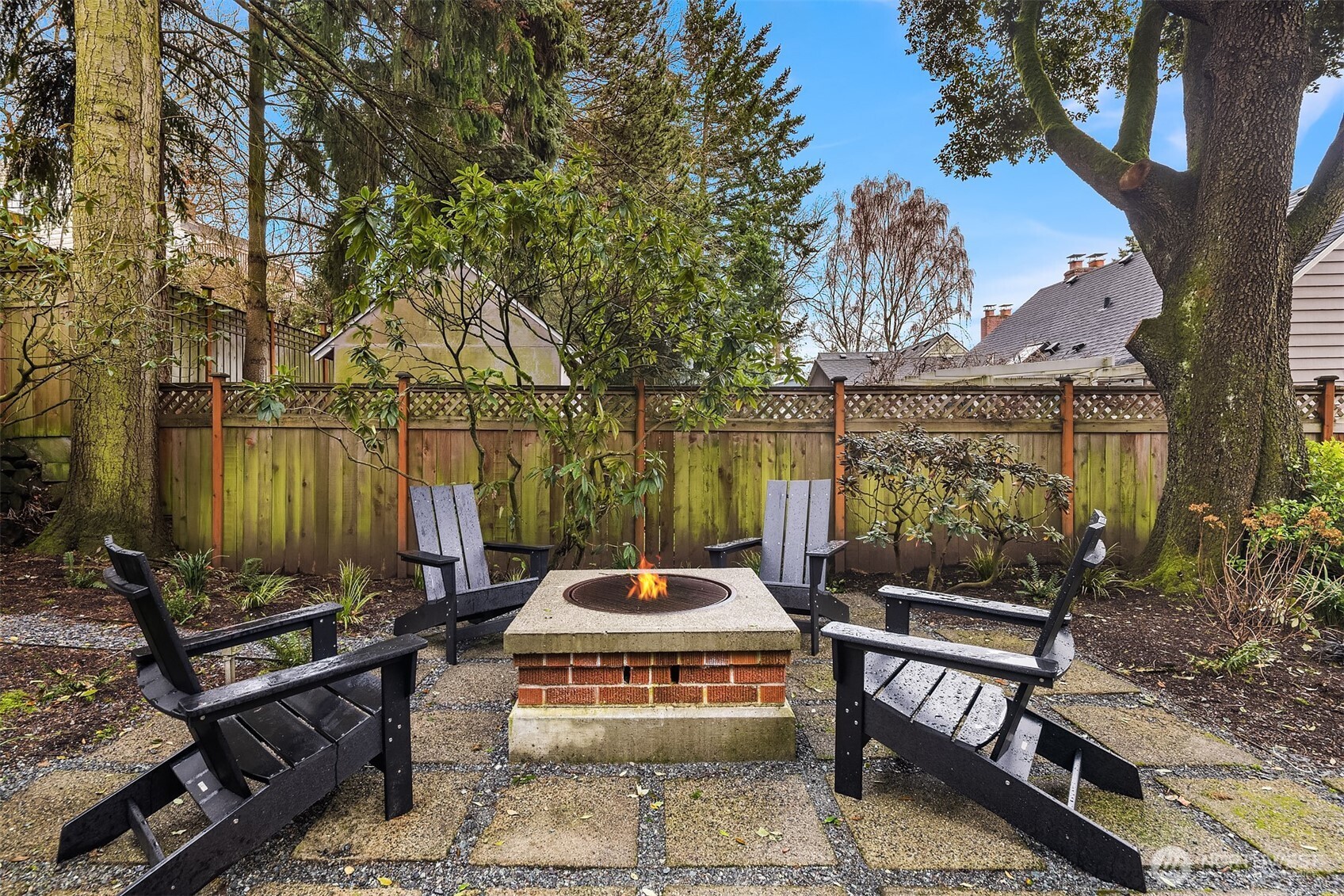 7016 28th Avenue Northeast Seattle, WA 98115 - Photo 32 of 32 a table and chairs sitting in a backyard next to a house