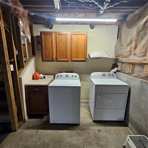 a utility room with a sink a washer and dryer