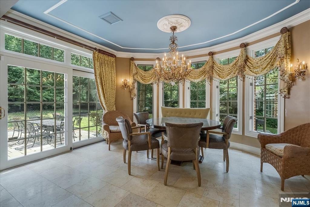 294 Oakwood Road Englewood, NJ 07631 - Photo 14 of 50 a view of a dining room with furniture large windows and wooden floor