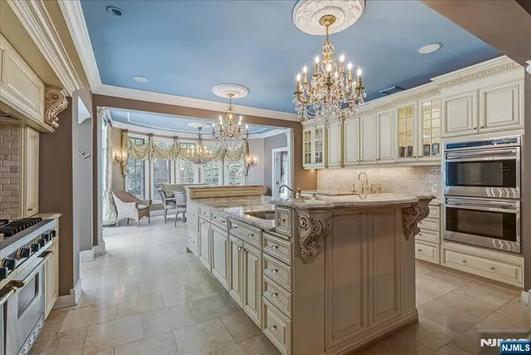 a kitchen with stainless steel appliances granite countertop a stove oven and a refrigerator