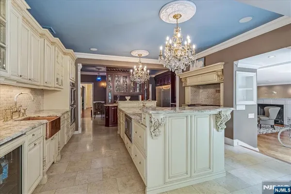 a kitchen with kitchen island granite countertop a stove oven and a refrigerator