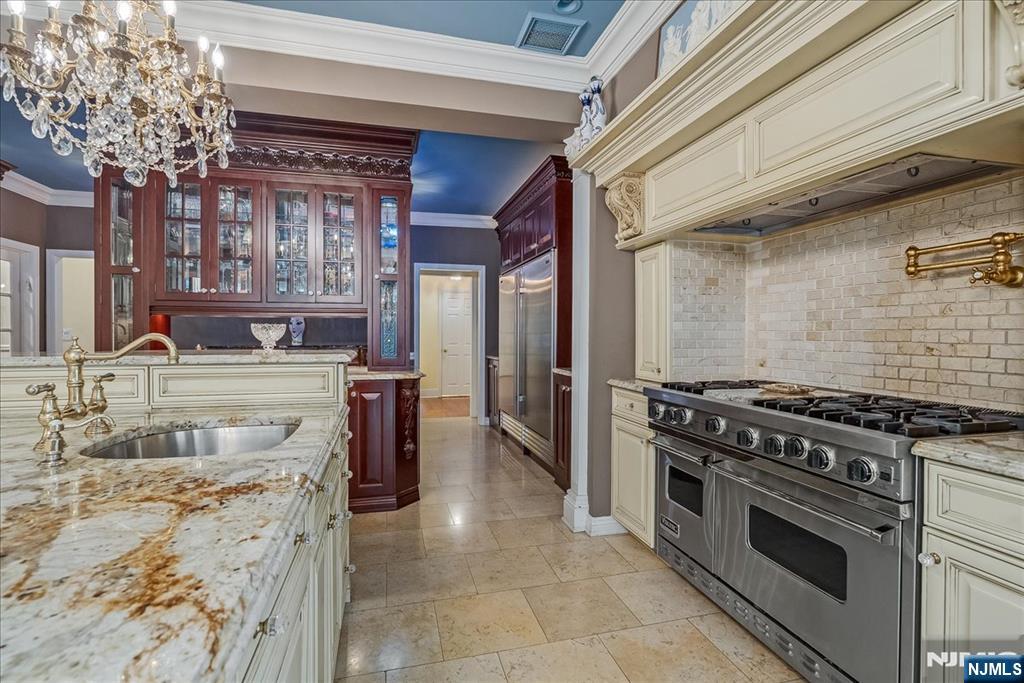 294 Oakwood Road Englewood, NJ 07631 - Photo 17 of 50 a kitchen with stainless steel appliances granite countertop a stove and a sink