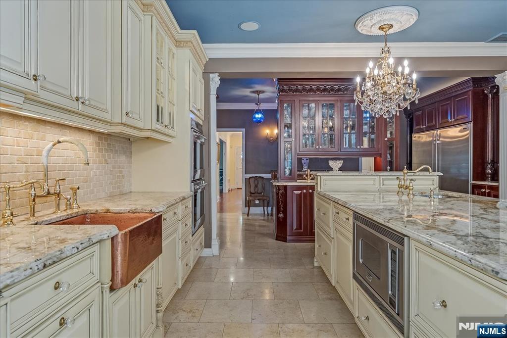 294 Oakwood Road Englewood, NJ 07631 - Photo 18 of 50 a kitchen with stainless steel appliances granite countertop a sink stove and refrigerator