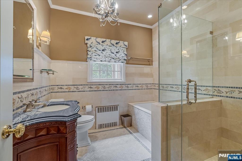 294 Oakwood Road Englewood, NJ 07631 - Photo 25 of 50 a bathroom with a sink a mirror and a shower