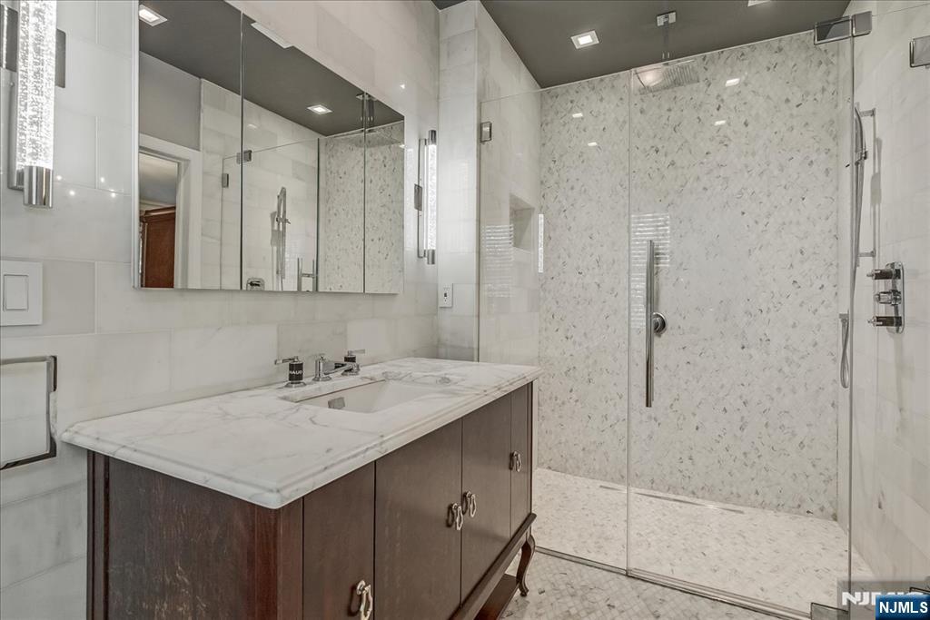 294 Oakwood Road Englewood, NJ 07631 - Photo 28 of 50 a bathroom with a sink and a mirror