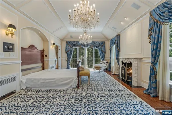 a living room with furniture a fireplace and a chandelier