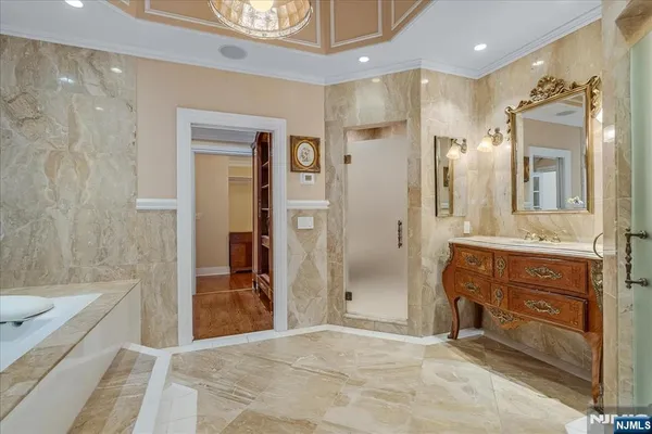 a bathroom with a sink a vanity a mirror and a bathtub